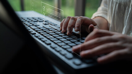 A person types on a laptop keyboard, showcasing hands in focus as digital icons appear above. This...
