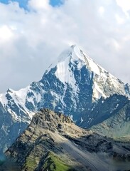 Fototapeta premium High altitude pyramidal snow peak with sharp rocky ridges in alpine range