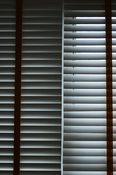 Interior of a modern room with horizontal window blinds, natural daylight.