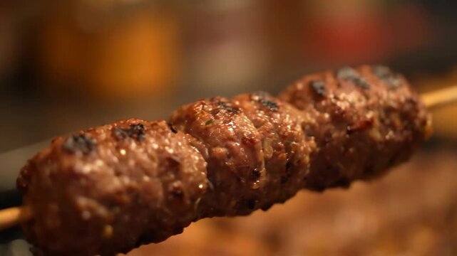 Juicy Minced Meat Kebab Skewer (Kofta) Grilling on a Hot BBQ Grill. Close-up of Delicious, Appetizing Barbecued Ground Meat for Dinner or Street Food Meal.