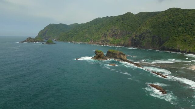 Large Rocks In Ocean Pounded By Waves South East Java Pantai Papuma Jember Indonesia Drone Track In 4K 60FPS