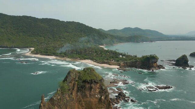 Tropical Pantai Papuma Jember Java Indonesia Dramatic Rock Cliffs In Southern Ocean Drone Track Back 4K 60FPS