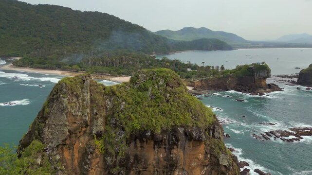 Reveal Shot Of Pantai Papuma Beach Rugged And Wild South Java Indonesia Drone Track In Over Cliff 4K 60FPS