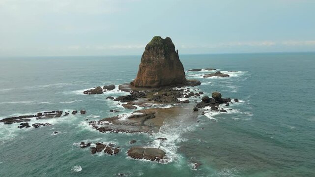Pulau Kajang Lone Rock In Rugged Waves East Java Indonesia Drone Rise 4K 60FPS