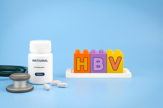 HBV letter blocks with antiviral medicine bottle and tablets on blue background representing hepatitis B awareness, antiviral treatment and viral infection healthcare