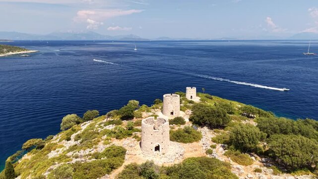 Beautiful Kioni windmills - drone flyover on a hot sunny day, Ithaca, Greek Islands