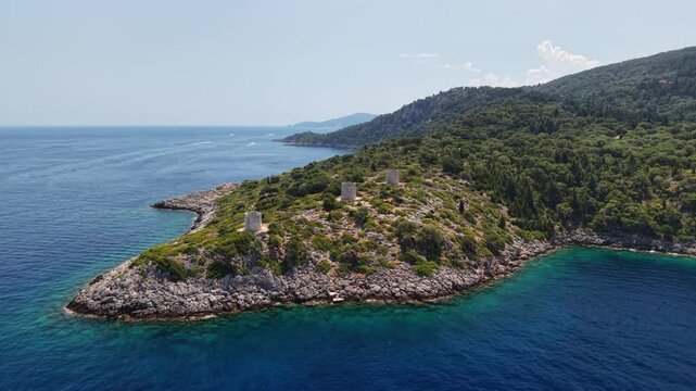Kioni windmills - drone move in and clockwise rotate, revealing stunning Kioni harbour, Ithaca, Greek Islands