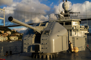 Naklejka premium War Ship during sail under bridge in Bosphorus