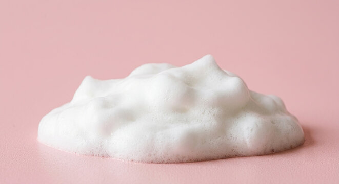 white foam resting on soft light pink background