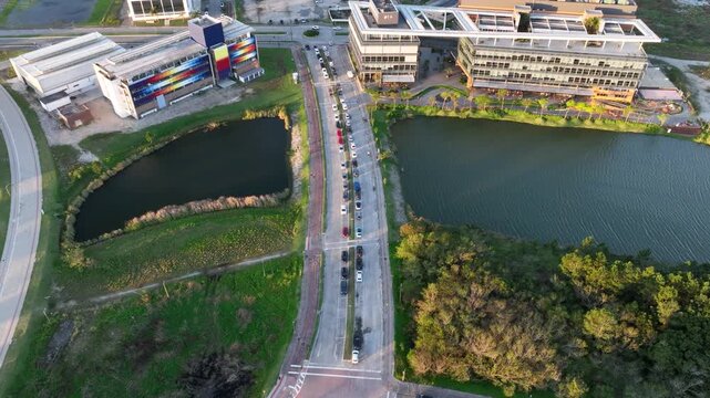 Artificial Lake Integrated with Modern Technology Buildings and Green Infrastructure in Florian&oacute;polis, Brazil. Establishing Shot. Aerial View.