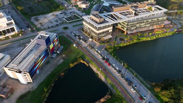 Artificial Lake Integrated with Modern Technology Buildings and Green Infrastructure in Florian&oacute;polis, Brazil. Establishing Shot. Aerial View.