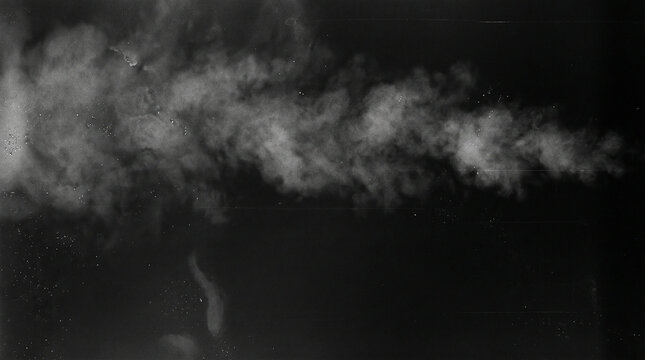 White fluffy smoke cloud blowing across a solid black background