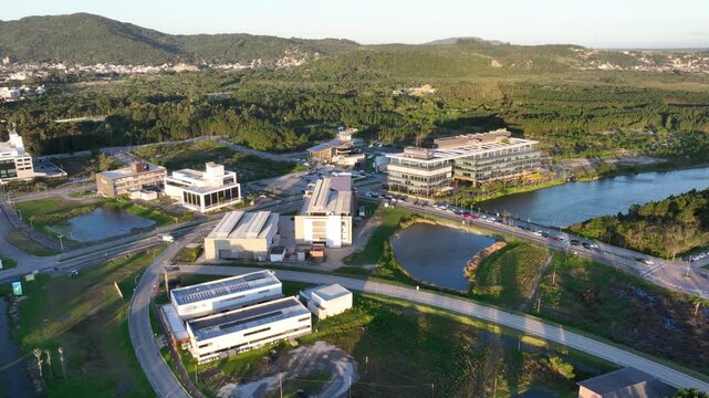 Artificial Lake Integrated with Modern Technology Buildings and Green Infrastructure in Florian&oacute;polis, Brazil. Establishing Shot. Aerial View.
