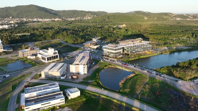 Artificial Lake Integrated with Sustainable Infrastructure, Modern Buildings and Preserved Green Landscape in Florian&oacute;polis, Brazil. Establishing Shot. Aerial View.