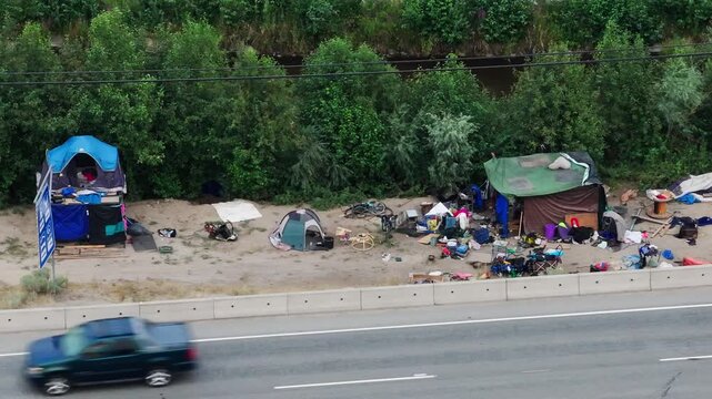 Homeless tents and shelters beside a busy road