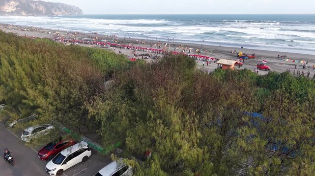 4K drone footage of Indonesia's 480-meter red and white flag unfurled at Parangtritis Beach, celebrating Indonesian Independence Day and national pride.