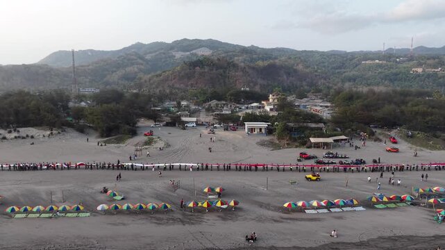 4K drone footage of Indonesia's 480-meter red and white flag unfurled at Parangtritis Beach, celebrating Indonesian Independence Day and national pride.