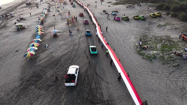 4K drone footage of Indonesia's 480-meter red and white flag unfurled at Parangtritis Beach, celebrating Indonesian Independence Day and national pride.