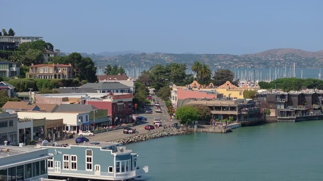 Drone shot of Sausalito town center and Bridgeway with traffic and people passing by