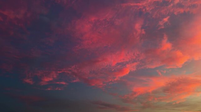 Fiery Sunset Illuminates Clouds Across The Evening Sky With Warm Glowing Light. Low-angle Sideways Shot
