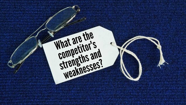 Glasses and paper tags with the words What are the competitor's strengths and weaknesses? evaluating what rival businesses do well and where they fall short in the market.