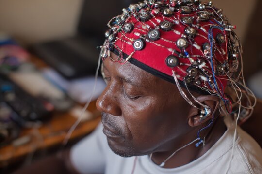 Man with EEG cap during neurological research with selective focus and natural light