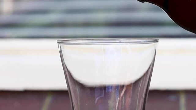 Video pouring a glass of beer, looks like it is only foam or froth.
