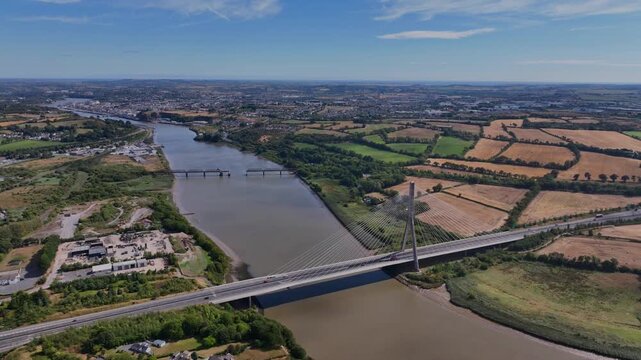 drone pullback summer scene Thomas Francis Meagher Bridge with Waterford City and wide River Suir amazing aerials Ireland