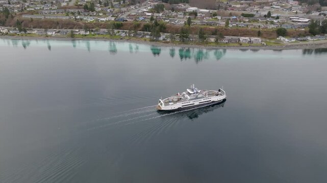 Drone shot of herring spawn happening on the shore of Port McNeill with ferry arriving
