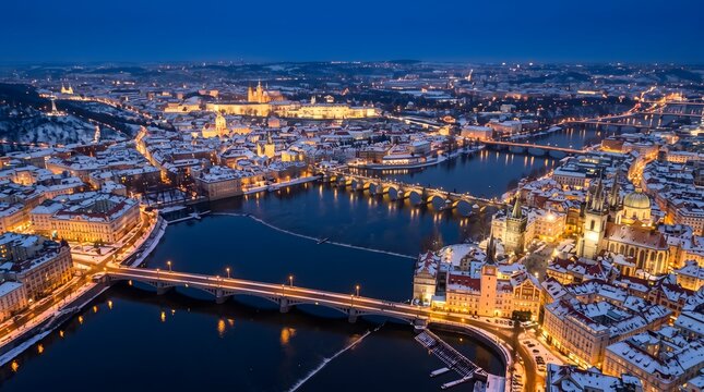 Prague skyline with Charles Bridge and Vltava River in winter at blue hour