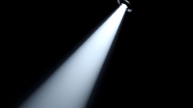 Bright white spotlight beam shining diagonally against a pitch black background.