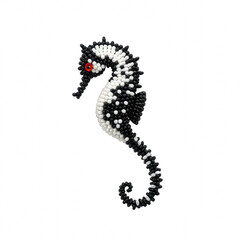 Fototapeta premium Black and white beaded seahorse brooch isolated on black