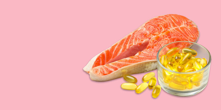 Omega 3. Salmon fillet is placed next to golden omega capsules on vibrant backdrop.