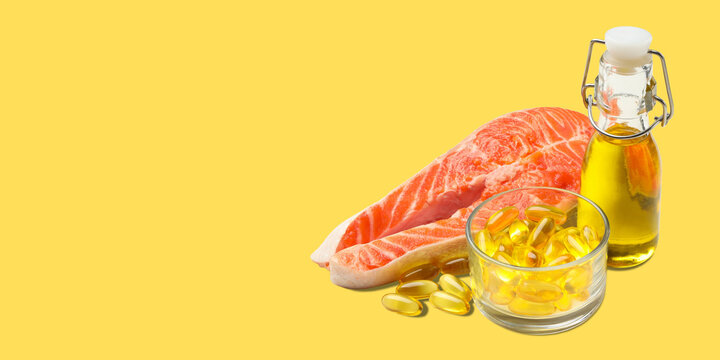 Omega 3. Fresh salmon fillet alongside omega fish oil capsules and bottle. Nutrition concept.