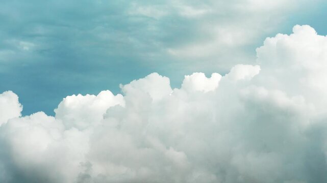 White clouds time lapse. Clouds running across the blue sky. 4k Time lapse of white clouds with blue sky background. Weather concept b roll shot.