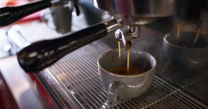 Professional coffee maker. Espresso recipe. Steaming aroma drink brewing on cafeteria automatic appliance pouring in mug metal horn.