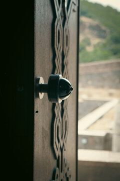 Wooden door with iron door knob, close-up,