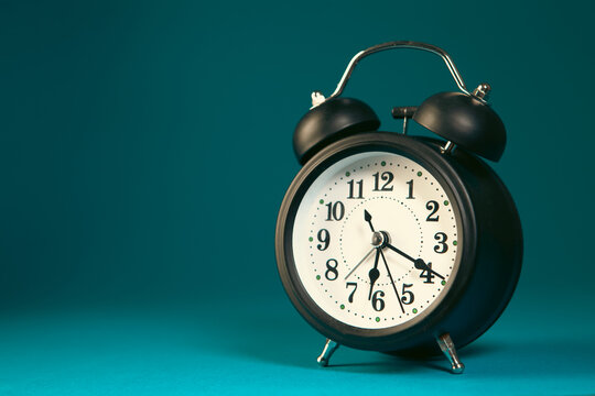 Retro alarm clock on a blue background with copy space. Time concept