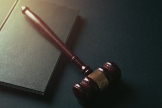 Judge gavel and book on black background. Law and justice concept.