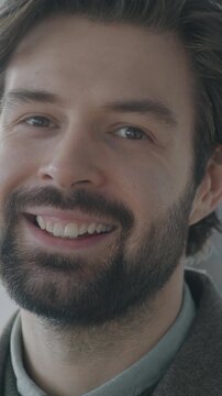  portrait of cheerful young businessman smiling looking at camera in office. People and positive emotion at work concept.