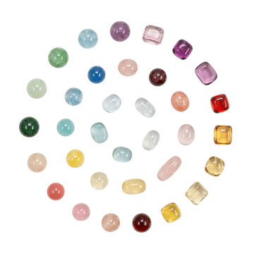 Collection of assorted colorful gemstones and polished cabochon beads arranged in a spiral pattern isolated on a transparent background