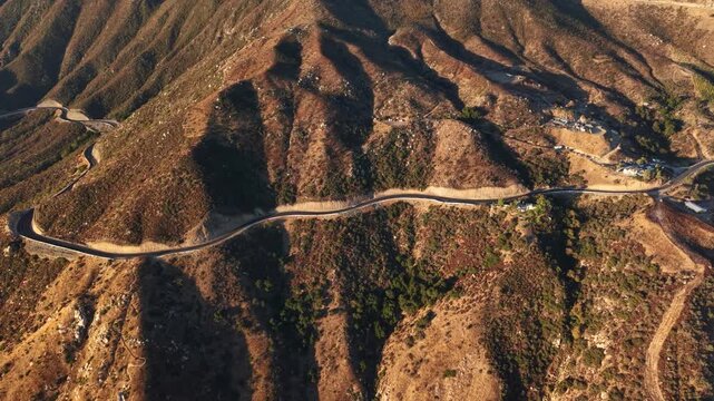Aerial View of Ortega Highway in Southern California at Sunrise. The Drone Camera zooms out from a traveler along this iconic stretch of road connecting Riverside to San Juan Capistrano