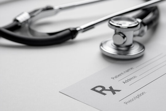 Stethoscope and prescription Rx pad for medical care.