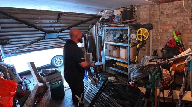 Time lapse male cleaning clutter and arranging messy household garage space