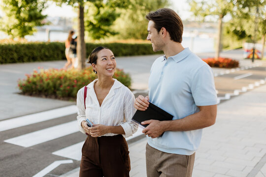 Enjoying a sunny stroll beside the water with laughter and smiles
