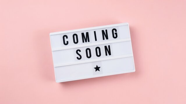 A cinema lightbox displays the message Coming Soon on a pastel pink background. This is a perfect visual for marketing campaigns and new product launches.