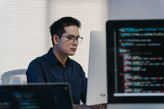 Asian programmer coding software engineering in office