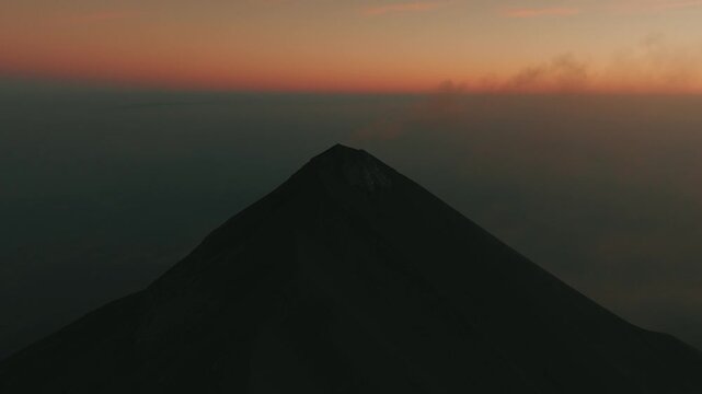 Aerial drone capture of Volcan de Fuego erupting at sunrise, dramatic ash and smoke cloud above volcano