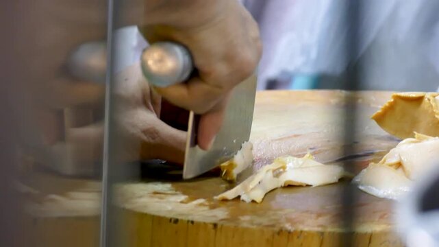 Asian Man Cut Fresh Abalone into Pieces, Close Up