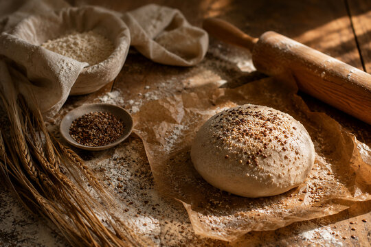 Artisan bread dough with flour, seeds and traditional baking tools